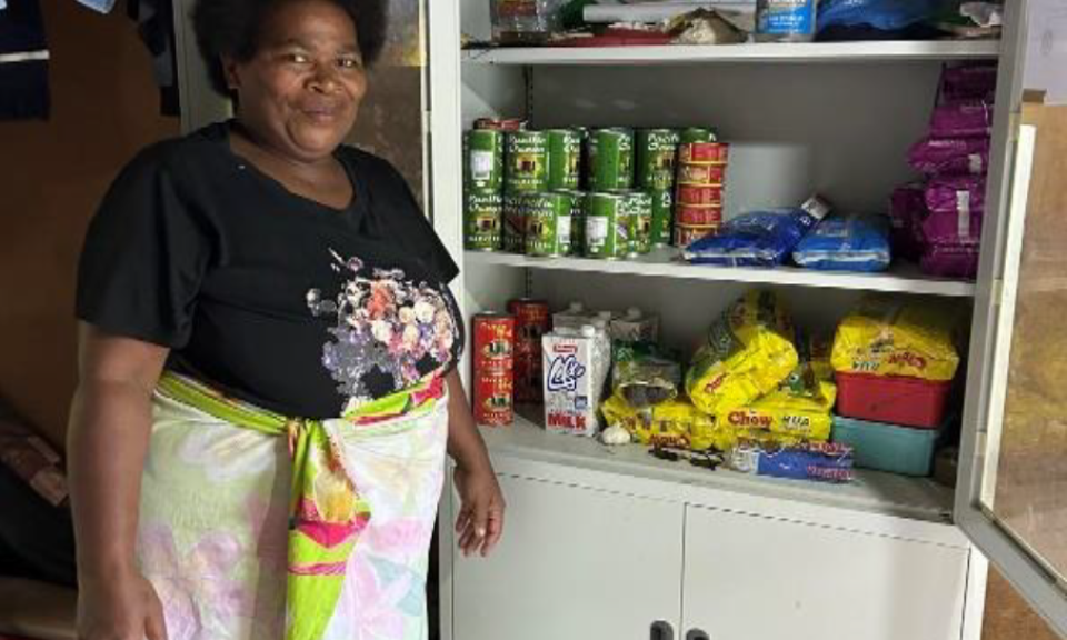 Matelita beside her canteen cupboard