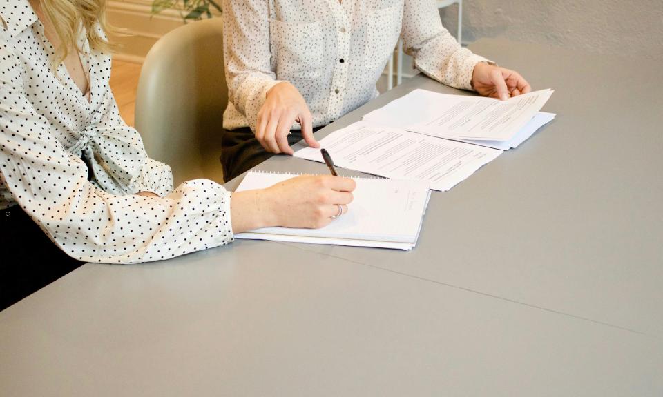 Women discussing documents. Copyright free photo